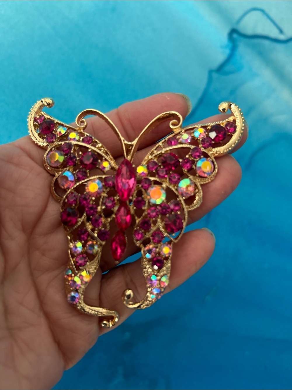 Private Label Gold-Tone Butterfly Brooch with Fuchsia and Aurora Stones  Dr 50